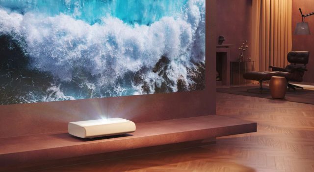 Samsung Premiere 9 projector in a living room displaying 4K resolution on a large screen.